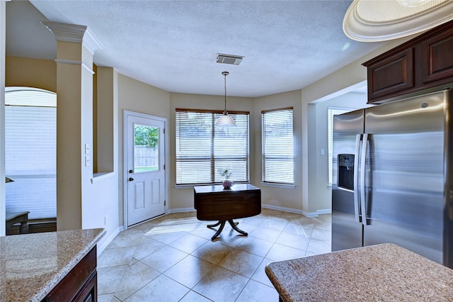 14022 Ashland Landing Dr, Cypress, TX 77429 - kitchen featuring stainless steel fridge, hanging light fixtures, baseboards, dark brown cabinetry, and a textured ceiling