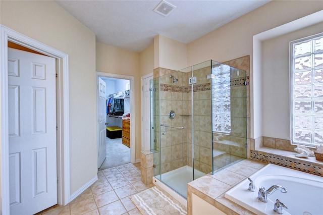 14022 Ashland Landing Dr, Cypress, TX 77429 - bathroom featuring a bath, a stall shower, a walk in closet, and tile patterned floors