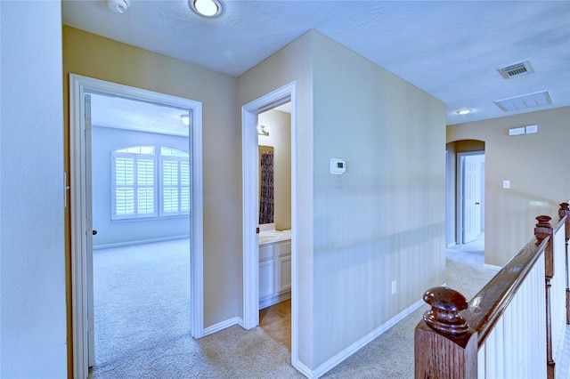 14022 Ashland Landing Dr, Cypress, TX 77429 - corridor with light carpet, arched walkways, baseboards, and an upstairs landing