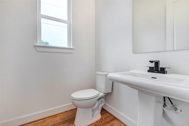 9428 Campbell Rd Unit B, Houston, TX 77080 - half bath with toilet, baseboards, wood finished floors, and a sink