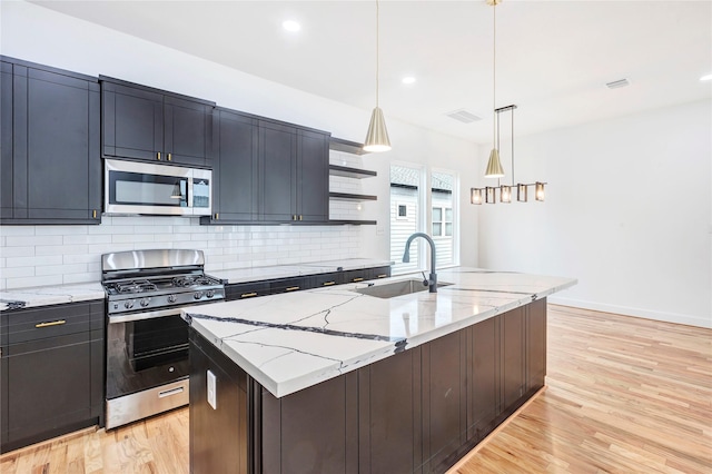9428 Campbell Rd Unit B, Houston, TX 77080 - kitchen featuring stainless steel appliances, a sink, light wood-style flooring, decorative backsplash, and light stone countertops
