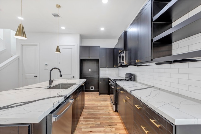9428 Campbell Rd Unit B, Houston, TX 77080 - kitchen featuring stainless steel appliances, a sink, open shelves, light wood-style flooring, and backsplash