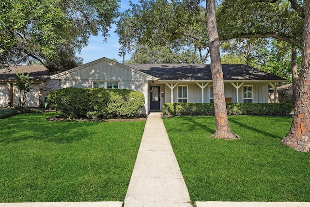 ranch-style home with a front lawn and board and batten siding