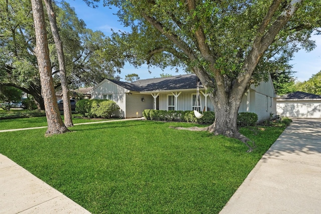 ranch-style home featuring a front lawn and board and batten siding