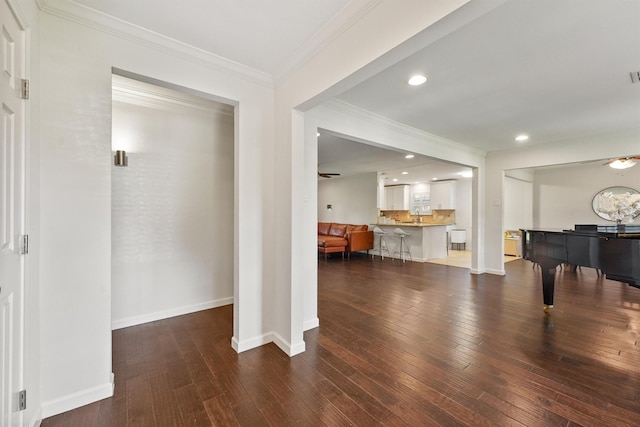 entrance foyer featuring ornamental molding, hardwood / wood-style flooring, baseboards, and recessed lighting
