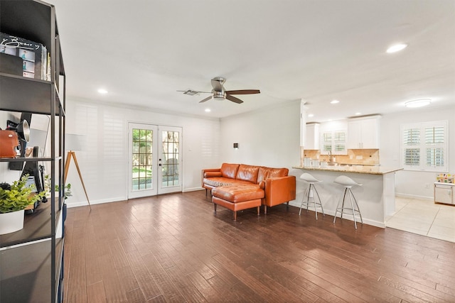 living room with a ceiling fan, french doors, recessed lighting, baseboards, and wood finished floors