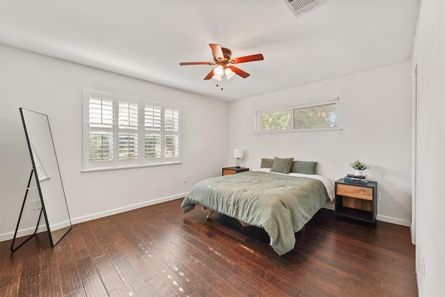 bedroom featuring baseboards, hardwood / wood-style flooring, and ceiling fan