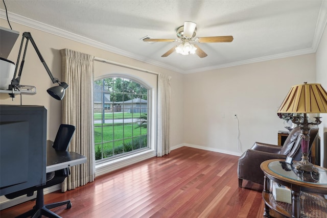 office area with wood finished floors, ceiling fan, crown molding, baseboards, and a textured ceiling