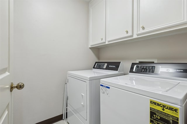washroom featuring washing machine and dryer and cabinet space