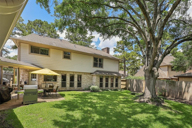 rear view of house with a patio area and a chimney