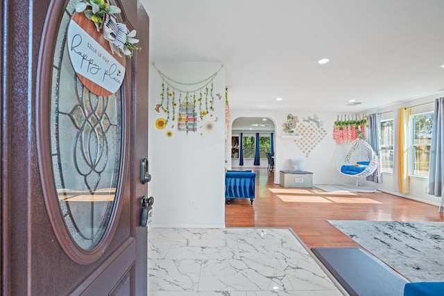 16815 Watering Oaks Ln, Houston, TX 77083 - entryway with arched walkways, recessed lighting, marble look tiles, and baseboards