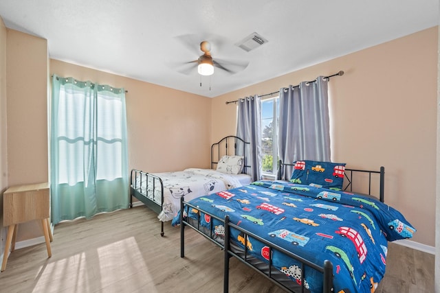 16815 Watering Oaks Ln, Houston, TX 77083 - bedroom with wood finished floors, baseboards, and ceiling fan