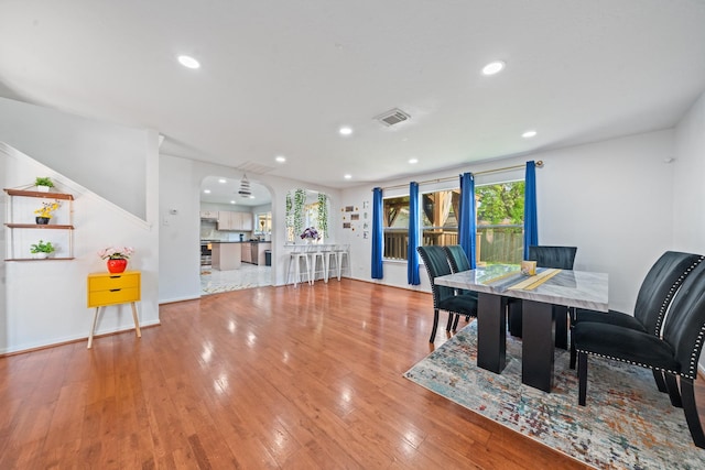 16815 Watering Oaks Ln, Houston, TX 77083 - dining space featuring arched walkways, hardwood / wood-style flooring, recessed lighting, and baseboards