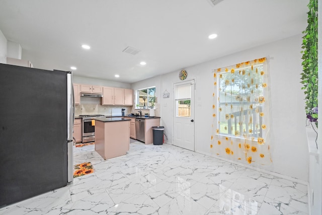 16815 Watering Oaks Ln, Houston, TX 77083 - kitchen featuring appliances with stainless steel finishes, recessed lighting, dark countertops, a kitchen island, and under cabinet range hood