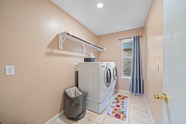 16815 Watering Oaks Ln, Houston, TX 77083 - laundry area featuring washing machine and dryer, light tile patterned floors, and baseboards