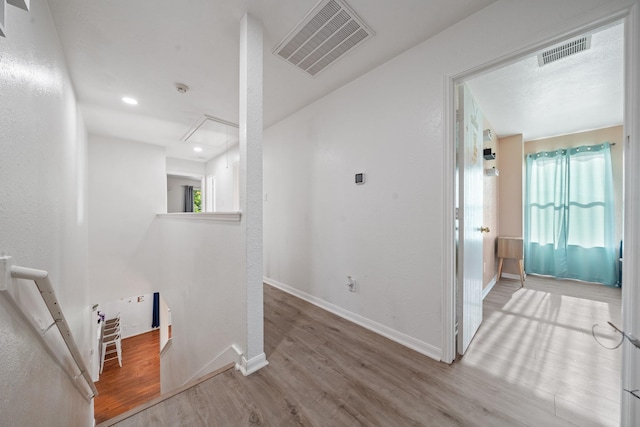 16815 Watering Oaks Ln, Houston, TX 77083 - hallway featuring an upstairs landing, wood finished floors, attic access, and baseboards