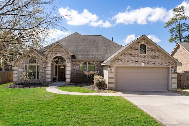french country inspired facade with brick siding, an attached garage, concrete driveway, and a shingled roof