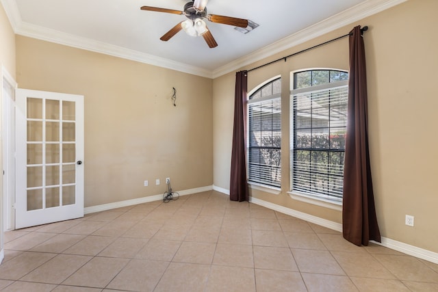 spare room with crown molding, a ceiling fan, light tile patterned floors, and baseboards