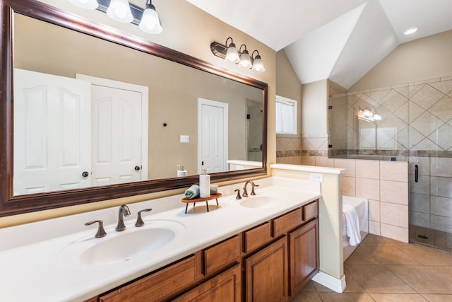 full bath featuring tile patterned flooring, a shower stall, vaulted ceiling, double vanity, and a garden tub