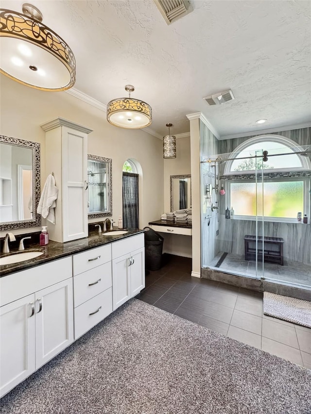 103 Deer Trl, Lake Jackson, TX 77566 - bathroom featuring tile patterned floors, a stall shower, double vanity, ornamental molding, and a textured ceiling