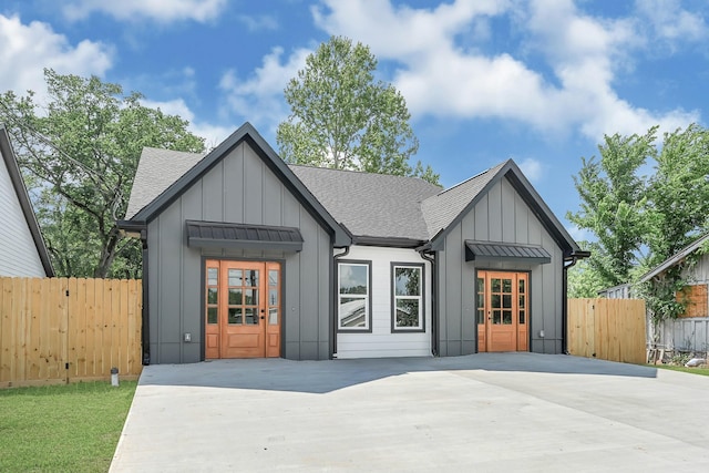 204 S 4th St, Conroe, TX 77301 - view of front of house featuring board and batten siding, roof with shingles, and fence
