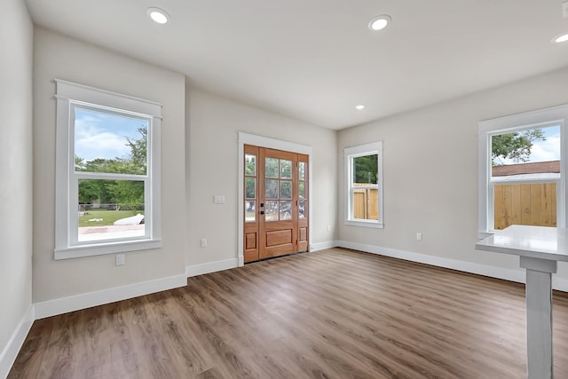 204 S 4th St, Conroe, TX 77301 - entrance foyer featuring plenty of natural light, wood finished floors, baseboards, and recessed lighting