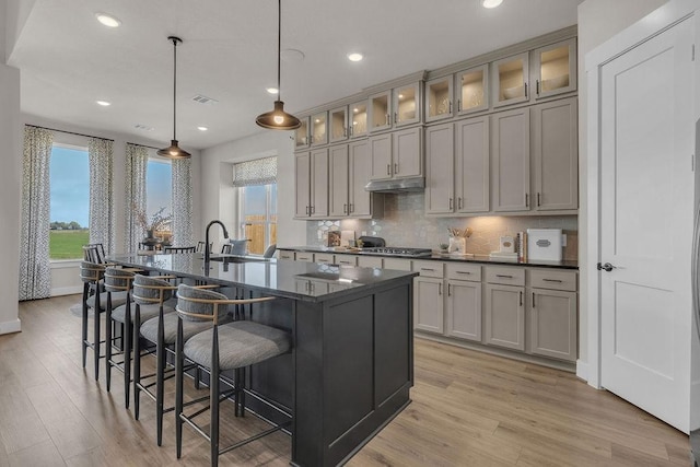 21705 Southern Valley Ln, New Caney, TX 77357 - kitchen featuring a sink, healthy amount of natural light, light wood-style flooring, tasteful backsplash, and recessed lighting