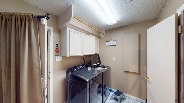 19115 Shay Ln, Humble, TX 77346 - laundry area featuring washer and clothes dryer, a textured ceiling, cabinet space, and baseboards