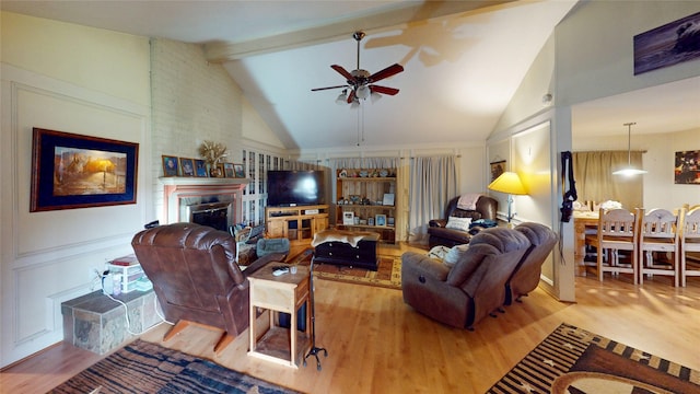 19115 Shay Ln, Humble, TX 77346 - living room featuring a ceiling fan, wood finished floors, beamed ceiling, a fireplace, and high vaulted ceiling