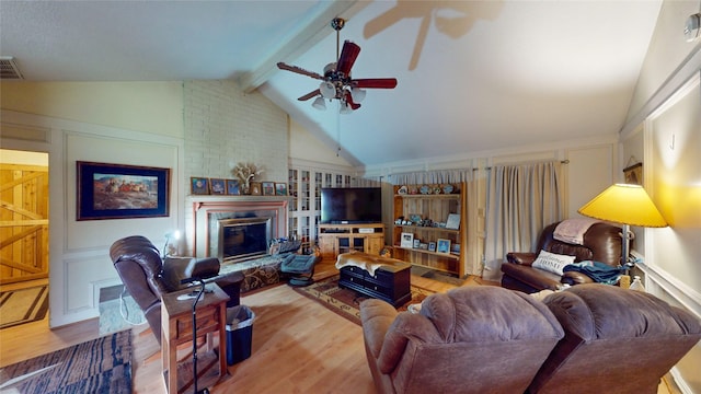 19115 Shay Ln, Humble, TX 77346 - living area with wood finished floors, ceiling fan, and a brick fireplace