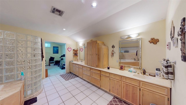 19115 Shay Ln, Humble, TX 77346 - full bath featuring vaulted ceiling, double vanity, tile patterned floors, recessed lighting, and a tub