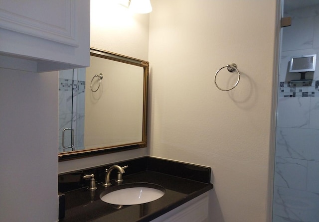 bathroom with vanity and a shower stall