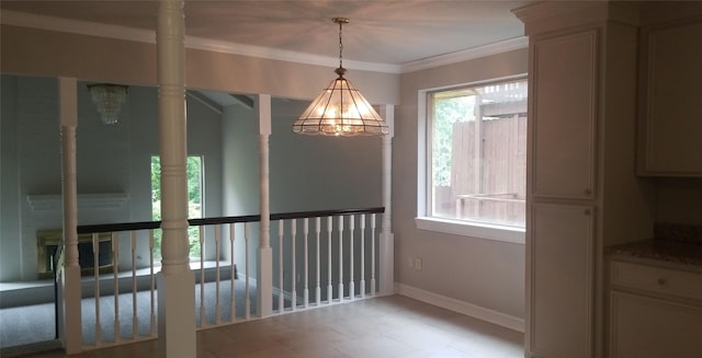 unfurnished dining area with baseboards, crown molding, and a chandelier