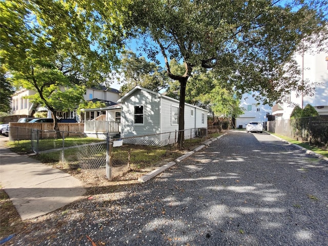 4302 Dickson St, Houston, TX 77007 - view of front of house featuring a fenced front yard, a residential view, central AC, and driveway
