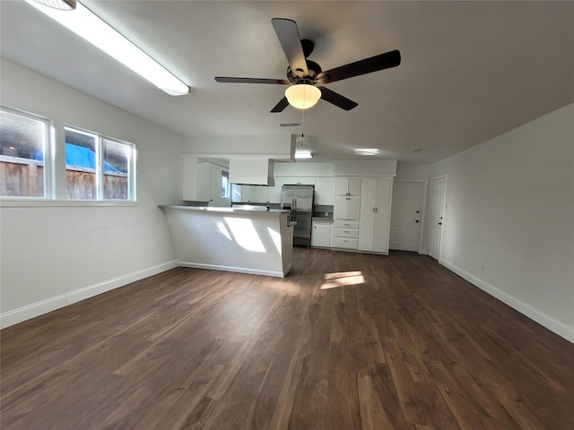4302 Dickson St, Houston, TX 77007 - kitchen featuring stainless steel fridge, white cabinets, a peninsula, baseboards, and dark wood-style flooring