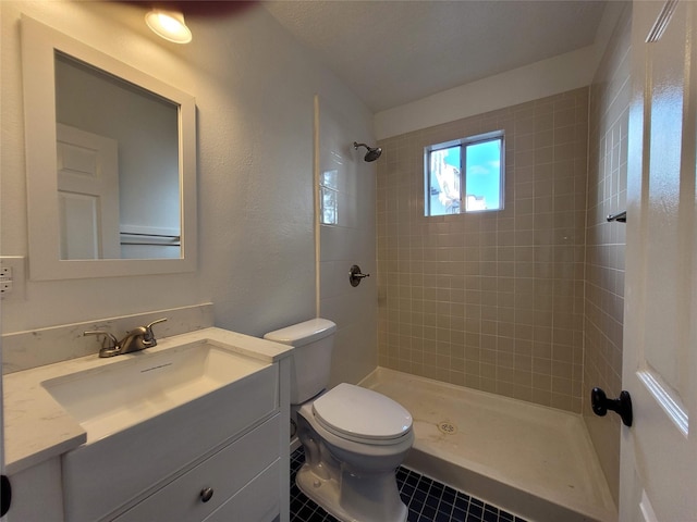 4302 Dickson St, Houston, TX 77007 - bathroom with toilet, tiled shower, vanity, and tile patterned floors