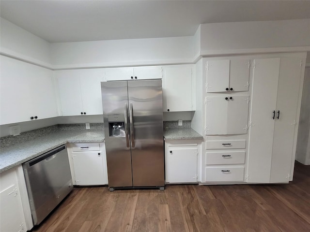 4302 Dickson St, Houston, TX 77007 - kitchen featuring appliances with stainless steel finishes, dark wood-style flooring, light countertops, and white cabinets