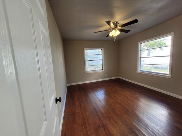 4302 Dickson St, Houston, TX 77007 - spare room with plenty of natural light, baseboards, ceiling fan, and dark wood-type flooring