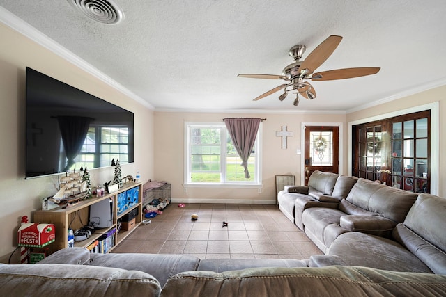 23114 Laura, New Caney, TX 77357 - tiled living area featuring crown molding, baseboards, ceiling fan, and a textured ceiling