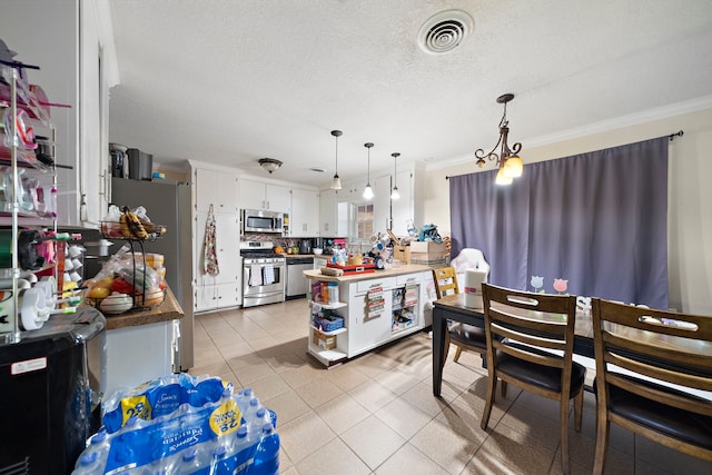 23114 Laura, New Caney, TX 77357 - kitchen featuring appliances with stainless steel finishes, white cabinets, crown molding, light tile patterned flooring, and a textured ceiling