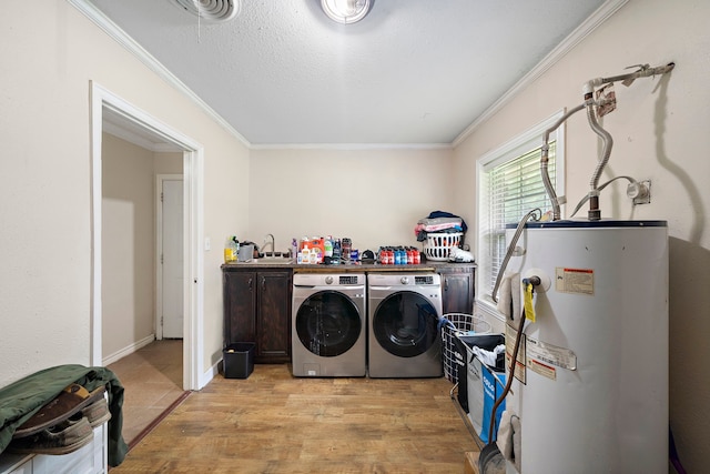 23114 Laura, New Caney, TX 77357 - laundry room featuring water heater, independent washer and dryer, light wood-style flooring, and crown molding