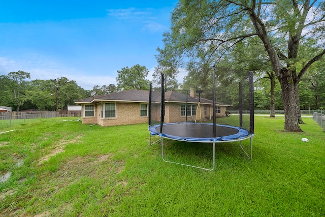 23114 Laura, New Caney, TX 77357 - rear view of property featuring a trampoline and brick siding
