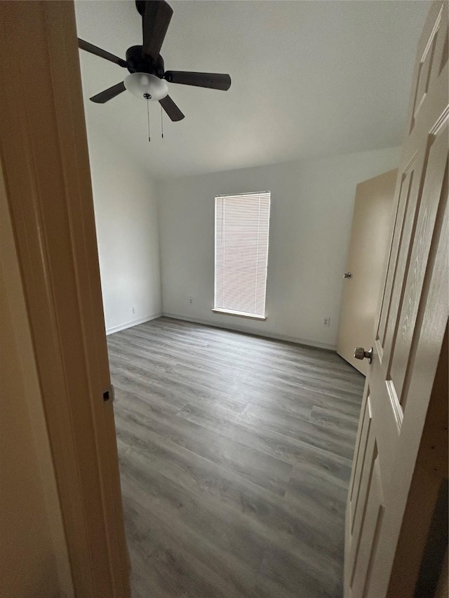 8702 Victorian Village Dr Unit 8702, Houston, TX 77071 - unfurnished room with wood finished floors, ceiling fan, vaulted ceiling, and baseboards