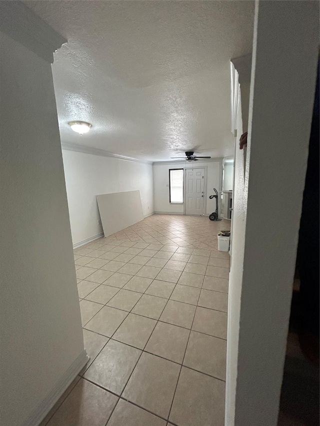 8702 Victorian Village Dr Unit 8702, Houston, TX 77071 - empty room featuring a textured ceiling, light tile patterned floors, ceiling fan, and baseboards