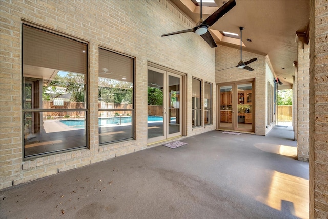 view of patio featuring french doors, a ceiling fan, and fence
