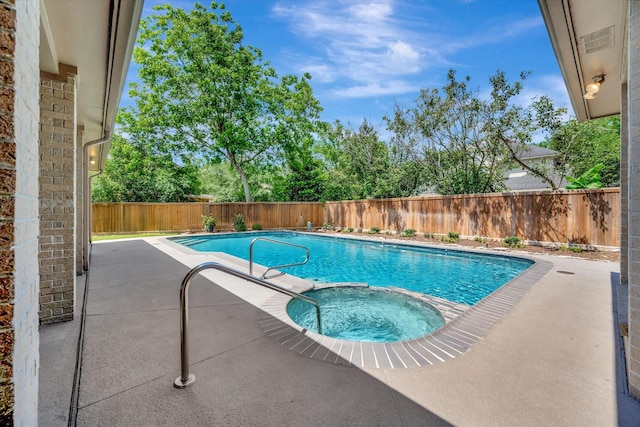 view of pool featuring a fenced backyard, a patio, and a pool with connected hot tub