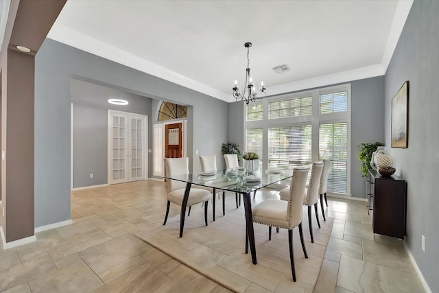 dining room featuring a chandelier, baseboards, french doors, and light stone finish floors