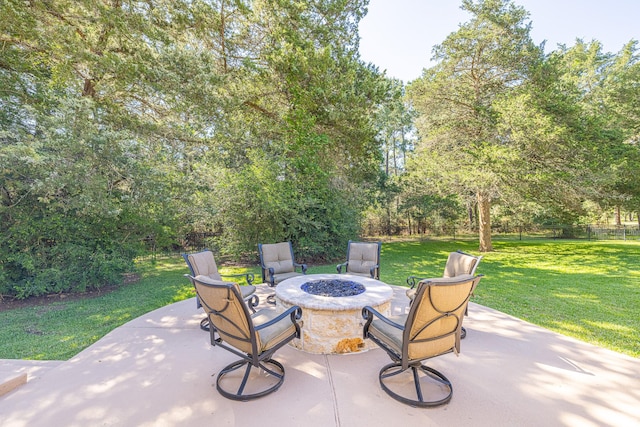view of patio / terrace with a fire pit and view of scattered trees