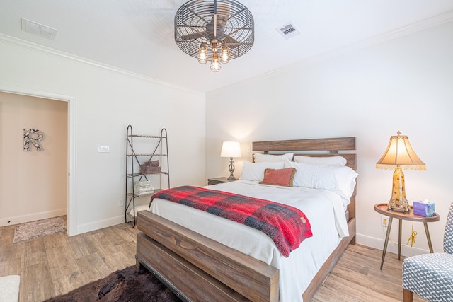 bedroom featuring crown molding, wood finished floors, and baseboards