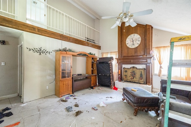 living area with a ceiling fan and lofted ceiling
